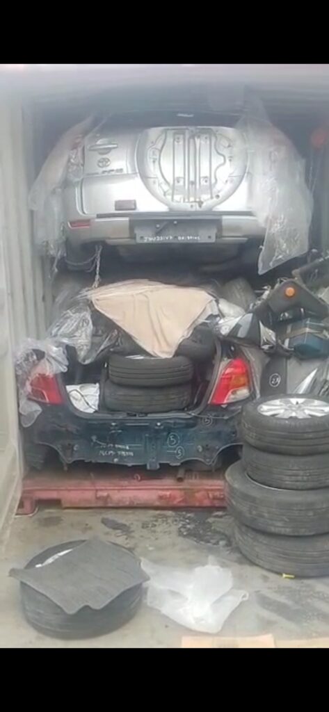 disassembled car parts packed shipping container.