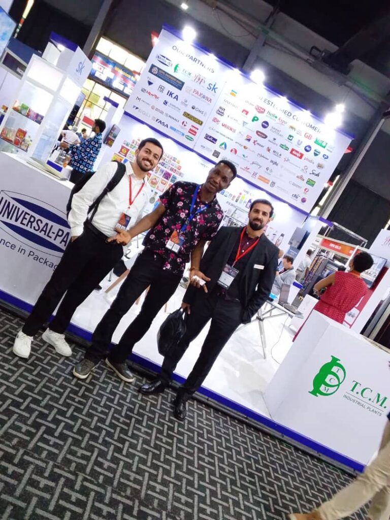 Group of company representatives giving thumbs up in front of a Gospower backdrop banner.