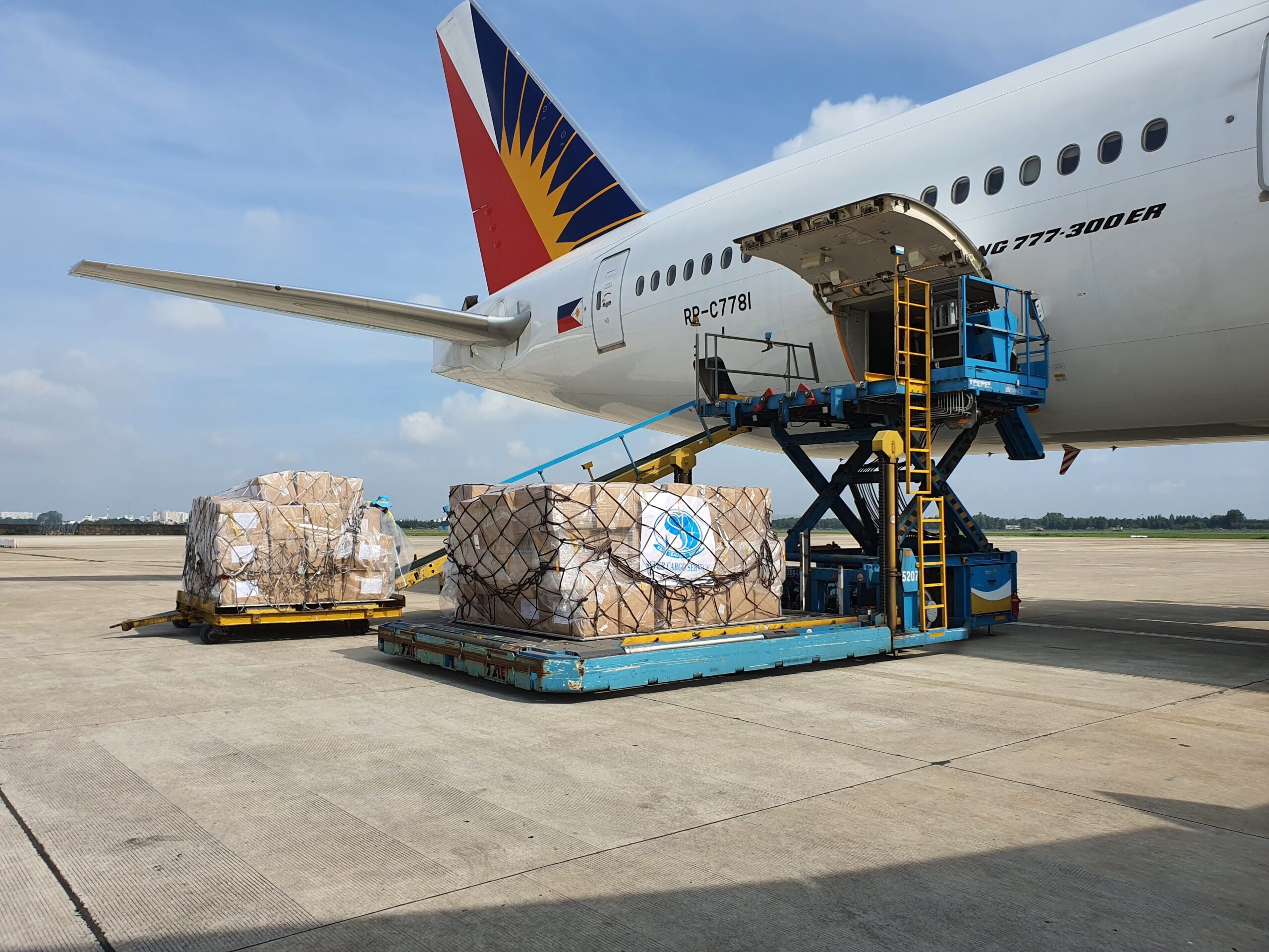 Home Cargo being loaded onto a commercial airplane at an airport in Ho Chi Minh City, Vietnam.